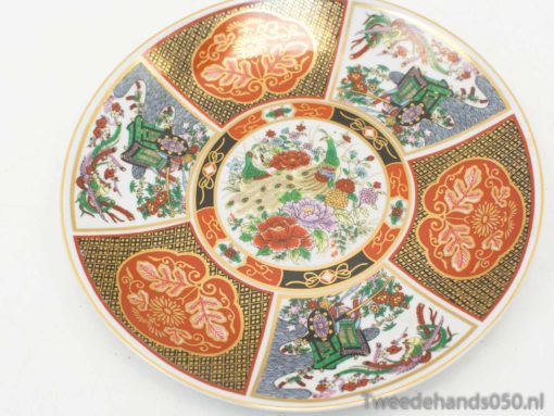 Vibrant vintage porcelain plate with floral patterns and gold accents, ideal for collectors and decor.
