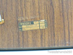 Vintage Philips 22RH426/01Z label on warm wood, perfect for retro electronics enthusiasts.