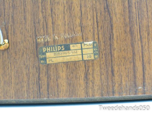 Vintage Philips 22RH426/01Z label on warm wood, perfect for retro electronics enthusiasts.