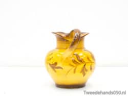 Elegant yellow ceramic jug with intricate leaf designs, perfect for decor or daily use.