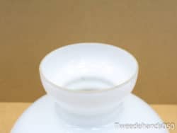 Elegant white vase with gold rim, perfect for stylish decor and floral arrangements.