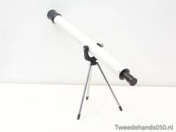 White telescope on sturdy tripod, ideal for beginner stargazers exploring the night sky.