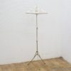 Stylish adjustable metal clothing rack for showcasing vintage fashion in homes and boutiques.