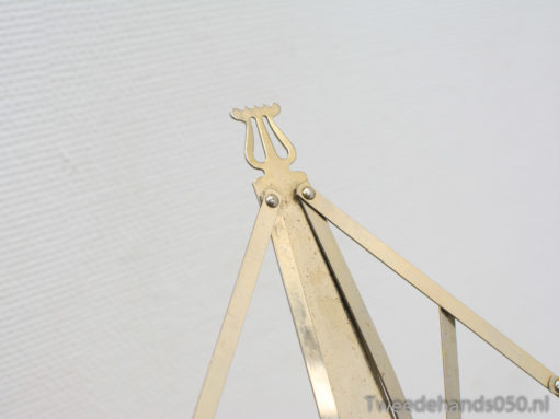 Polished brass easel with lyre design, perfect for art displays and elegant home décor.