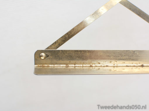 Vintage metal hanger with character and patina, ideal for displaying art and photos stylishly.