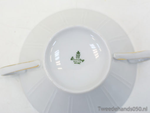Elegant porcelain teacup and saucer with gold trim, perfect for sophisticated tea gatherings.