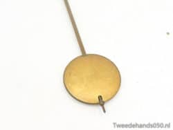 Antique brass measuring tool with a circular disc and slender rod, ideal for vintage collectors.