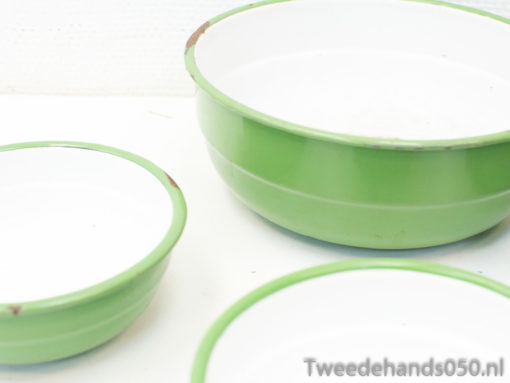 Vintage green bowls with white interiors, perfect for serving and charming kitchen decor.