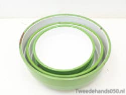Charming vintage green and white nesting bowls for stylish kitchen decor and practical use.