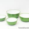 Vintage green bowls with glossy white interiors, ideal for mixing, serving, and nostalgic kitchen decor.