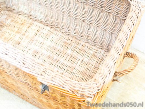 Elegant wicker basket with sturdy handles for stylish storage and rustic decor.