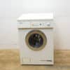 Compact Miele washing machine with large glass door and intuitive controls for modern homes.