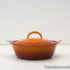Vibrant orange ceramic casserole dish for cooking and stylish meal presentation.
