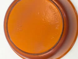 Vivid orange bowl with handles, ideal for versatile kitchen use and vibrant table decor.