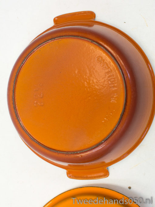 Vivid orange bowl with handles, ideal for versatile kitchen use and vibrant table decor.