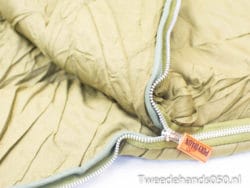 Stylish olive green quilted jacket with durable zipper, ideal for outdoor adventures and everyday wear.