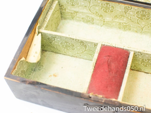 Antique wooden box with green floral lining and red velvet, ideal for storing treasures.