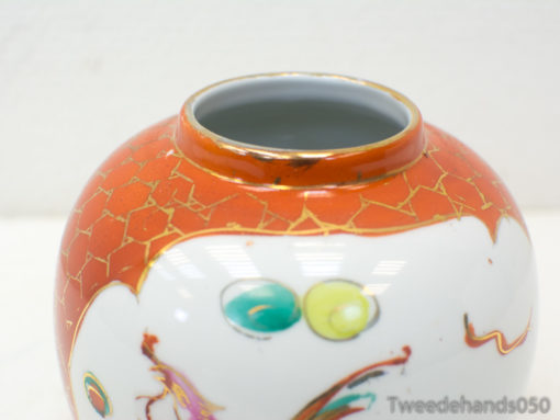 Elegant orange vase with gold accents and abstract designs, perfect for stylish home decor.