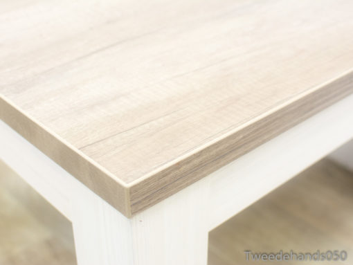 Stylish light wood coffee table with white legs, perfect for modern living spaces.