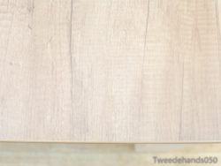 Elegant light wooden table showcasing unique grain patterns and a refined, rustic charm.