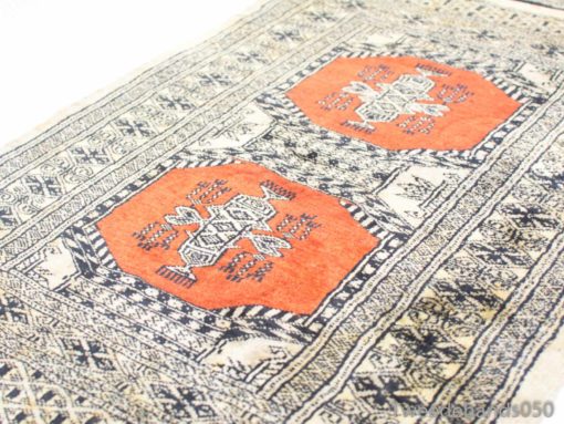 Colorful vintage tablecloth featuring orange octagons and intricate patterns for stylish decor.