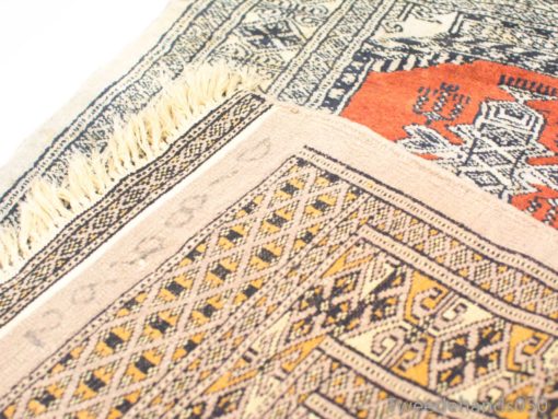 Vibrant vintage rug features intricate red and beige patterns that celebrate cultural craftsmanship.