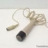 Classic beige handheld microphone with coiled cable, perfect for vintage audio collectors.