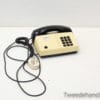 Beige and black vintage telephone, perfect for adding nostalgic charm to your decor.
