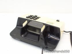 Vintage black and cream telephone, perfect for collectors and retro design enthusiasts.