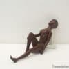 Stylized seated female figurine, ideal for adding elegance to contemporary decor.