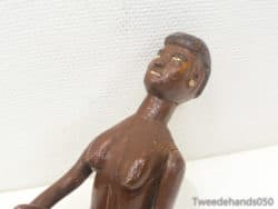 Handcrafted wooden figure with joyful expression and elegant finish, perfect for decor or collection.