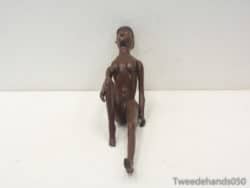 Elegant wooden sculpture of a seated woman, radiating tranquility and minimalistic charm for decor.