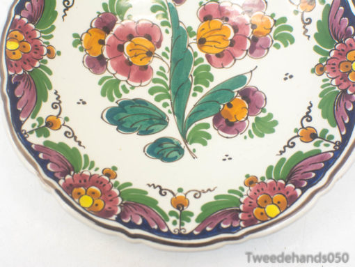 Elegant hand-painted ceramic plate with vibrant floral patterns and a chic purple border.