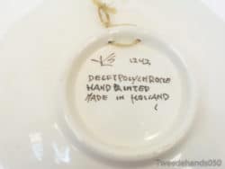 Hand-painted Delft plate model 1243 showcasing Dutch artistry and vibrant multicolored designs.