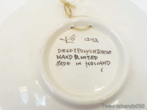 Hand-painted Delft plate model 1243 showcasing Dutch artistry and vibrant multicolored designs.