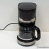 Sleek black coffee maker with glass carafe and stainless steel accents, perfect for modern kitchens.