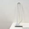 Sleek metal stand for organizing books and documents in modern home or office spaces.