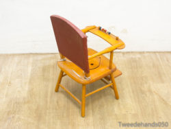 Vintage wooden high chair with red backrest and playful bead tray for joyful mealtimes.