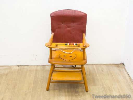 Vintage wooden childrens chair with a red backrest and colorful bead accents for fun activities.