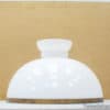 Elegant vintage white glass lamp shade with brass trim for stylish home decor.