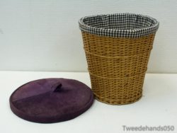 Chic wicker basket with purple lid and checkered lining for stylish home organization.