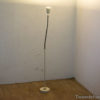Sleek modern floor lamp with white shade, perfect for cozy minimalistic spaces.
