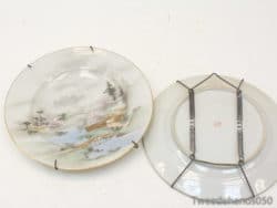 Elegant antique plate with gold trim and cherry blossom landscape, perfect for display and collection.