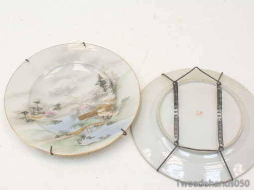 Elegant antique plate with gold trim and cherry blossom landscape, perfect for display and collection.
