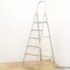 Vintage aluminum step ladder with 7 rungs, perfect for home tasks and stylish decor.