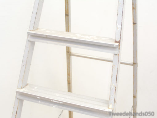 Weathered white vintage ladder with charm, perfect for decor and creative projects.