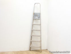 Vintage metal ladder with rustic charm, perfect for home improvement and stylish decor.