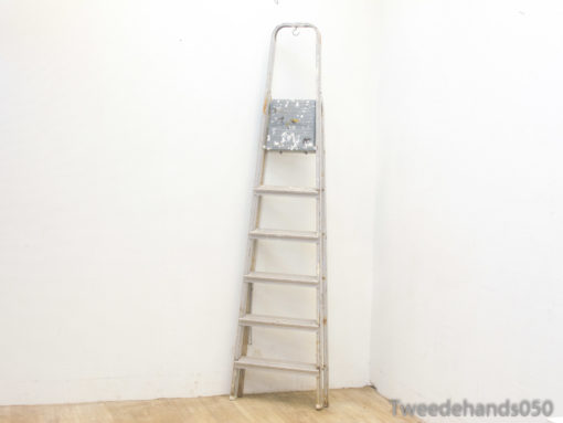Vintage metal ladder with rustic charm, perfect for home improvement and stylish decor.