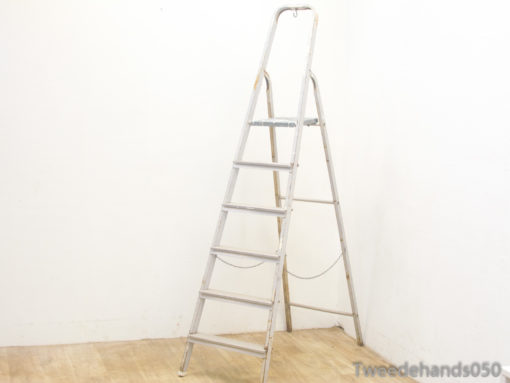 Vintage aluminum step ladder with 7 rungs, perfect for home tasks and stylish decor.