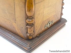 Elegant wooden box with intricate marquetry and keyhole, ideal for stylish storage and decor.